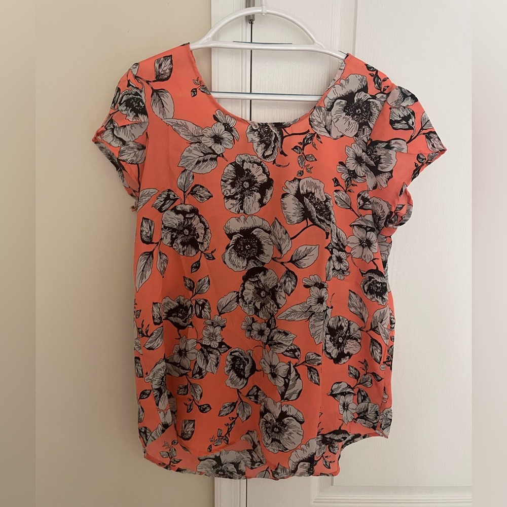 Orange shell with white and black flowers